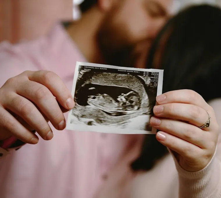 Parents holding their 12-week ultrasound print
